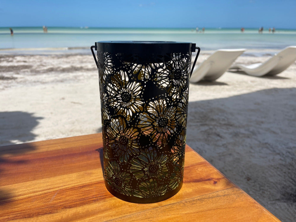 Black hanging Solar Lantern Large 10" tall - LITO on a table at the beach in the daytime