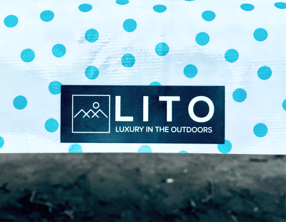 blue and white polka dot pattern on an outdoor tablecloth closeup with LITO logo and tagline