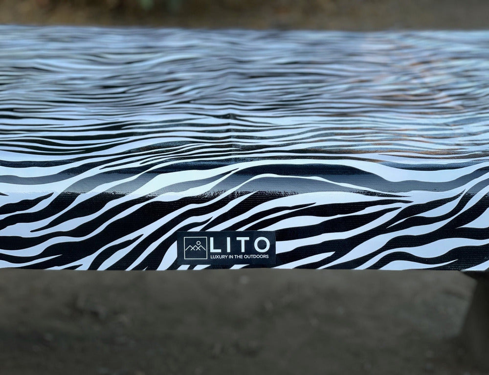 Zebra print shiny outdoor tablecloth with LITO logo and tagline