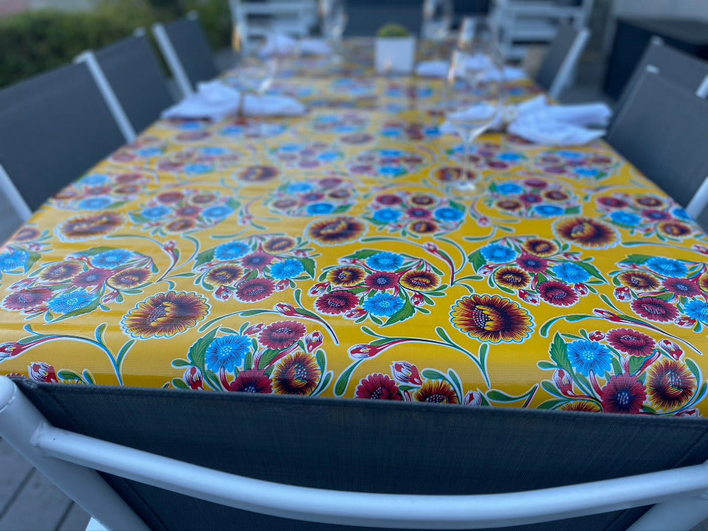 Yellow and red flowers in a pattern on an outdoor tablecloth