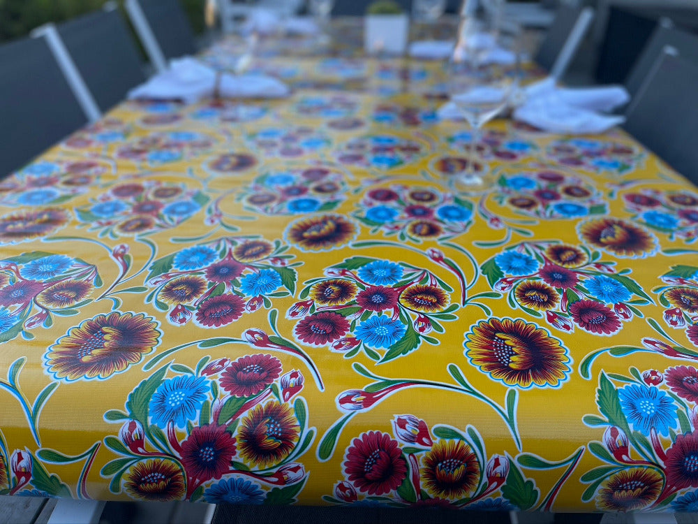 yellow and red flower pattern on a yellow background on a tablecloth